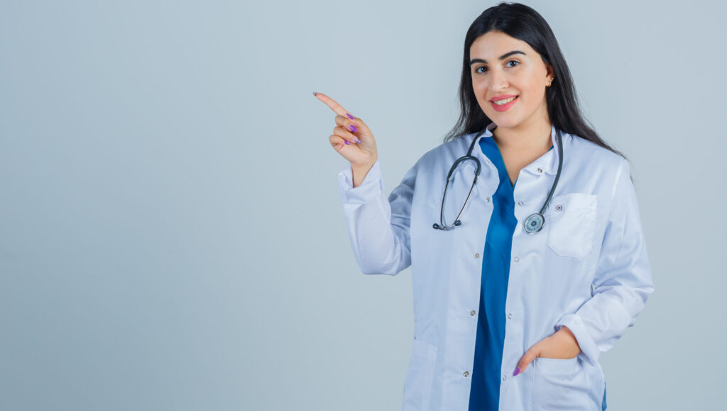 Female doctor pointing sideways, representing guidance for NRI PG medical seats